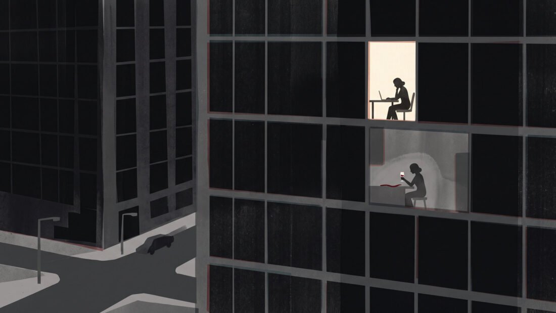 An office tower at night, one window lit near the top with a woman still at her desk, and her outline again in the glass below.