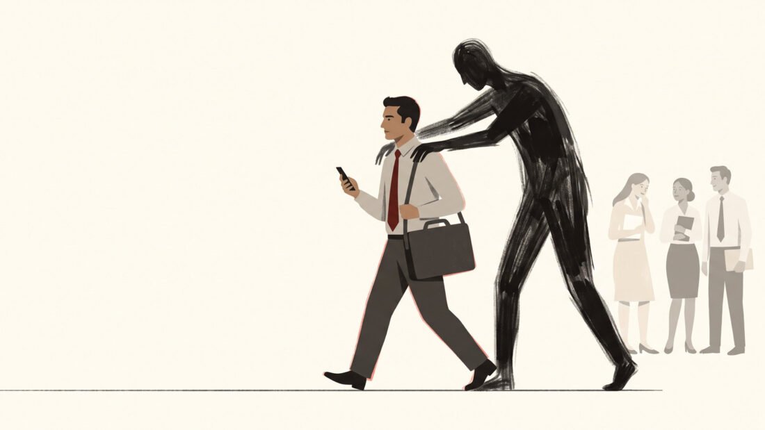 A composed man in a red tie walks briskly to work, a tall dark figure behind him with both hands on his shoulders.