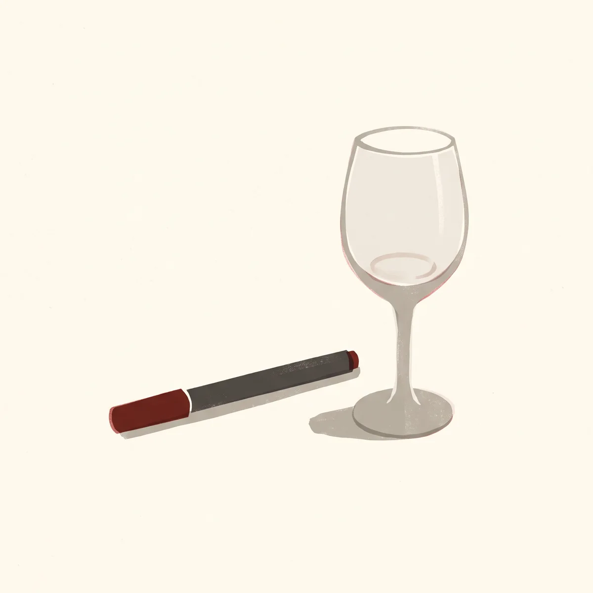 An injector pen with a red cap lies beside a stemmed wine glass that is empty except for a faint ring at the bottom.